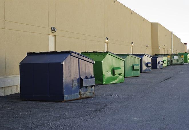 large construction dumpster positioned on a city street in Center Moriches